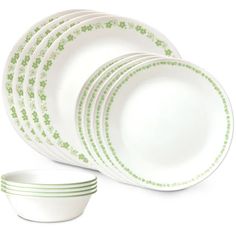 green and white dinnerware set on a white background with four bowls in the middle