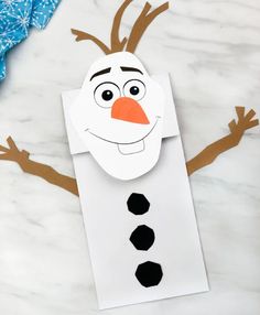 the paper snowman is cut out to make it look like he's smiling