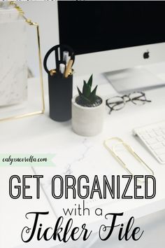 a desk with a computer, pen and glasses on it that says get organized with a ticker file