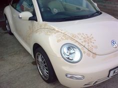 a white car parked in a parking lot next to another car with the door open