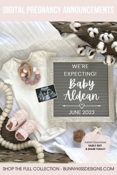 the baby announcement is displayed on top of a basket with other items and accessories around it