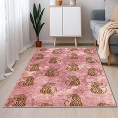 a pink rug with leopards on it in front of a white chair and potted plant