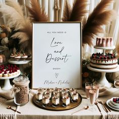 a table topped with cakes and desserts next to a sign that says love and dessert