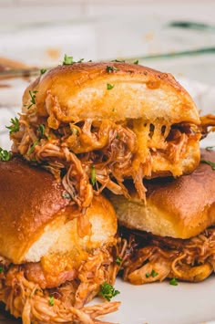 two pulled pork sandwiches stacked on top of each other