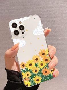 a woman holding up her phone case with sunflowers on it