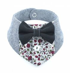 a dog collar with a bow tie on it's chest and a white background