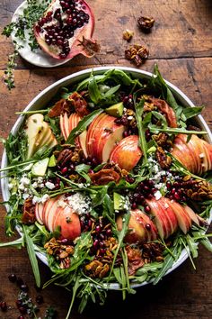 an apple salad with nuts and greens in a bowl