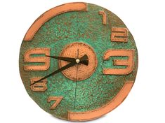 a clock with numbers on the face is green and gold, against a white background