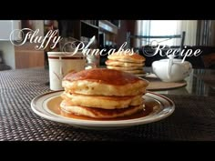 pancakes are stacked on a plate with syrup and coffee in front of them that says fluffy pancakes recipe