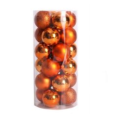 a clear container filled with orange and gold christmas bauble ornament balls