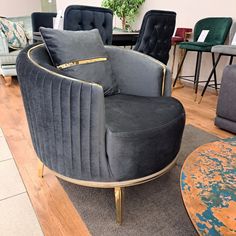 a living room filled with lots of furniture and decor on top of a hard wood floor