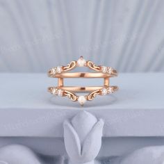 a gold ring sitting on top of a white box