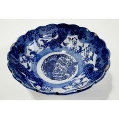 a blue and white bowl with an animal design on the bottom, sitting on a table