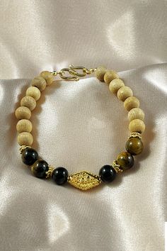 Shakti translates to "Power" in Sanskrit and is the divine inner power channel within each one of us, which when awakened, can inspire a deeper connection with our soul and create a path to abundant, joyful living. Our Shakti bracelet is designed to inspire soulful mastery in your endeavors. Featuring sacred Tulsi beads with Tiger's Eye and Black Onyx beads and a high energy gold vermeil Mantra bead, Shakti cuts through clouds of confusion and ignorance and illuminates your path towards a deeply Spiritual Onyx Beaded Bracelets, Spiritual Onyx Beaded Bracelets For Meditation, Joyful Living, Wrist Mala, Inner Power, Onyx Bead, Tigers Eye, Sanskrit, Tiger's Eye