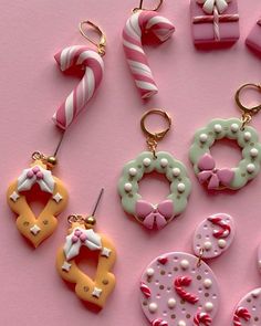 some candy and candies are laying out on a pink surface with gold key chains