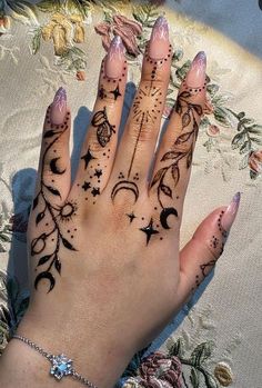 a woman's hand with tattoos on it