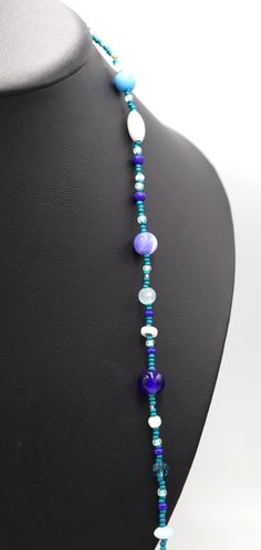 This Necklace with Blue You Away – Blue and White 38” Long Party Necklace by Monkey’s Mojo Southern statement necklace meets the fun and easy wear of light weight and cool glass. Inspired by the fun and festive beads thrown off Mardi Gras floats, this necklace is the perfect touch to complete any outfit. Limited 1 or 1. We couldn’t replicate this necklace if we tired. Materials Used: 11/0 Assorte4d Blue (Teal) and Silver Glass Beads 8/0 Assorted Aqua, Blue, and White Beads 6.5mm/8.4mm White Glas Blue Glass Beaded Chain Jewelry, Blue Round Bead Necklaces For Parties, Blue Beaded Chain Necklace For Party, Blue Round Beads Necklaces For Party, Blue Adjustable Long Necklace, Blue Long Necklace For Party, Turquoise Glass Necklaces For Party, Turquoise Glass Necklace For Party, Party Necklaces With Colorful Blue Beads