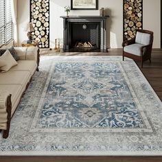 a living room filled with furniture and a large rug on top of a hard wood floor