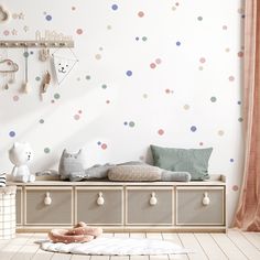 a child's room with polka dot wall decals on the walls and storage drawers