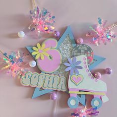 an ice skating themed birthday cake topper with glitters and sprinkles