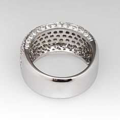 a white gold ring with diamonds on the inside and outside, set in 18k white gold