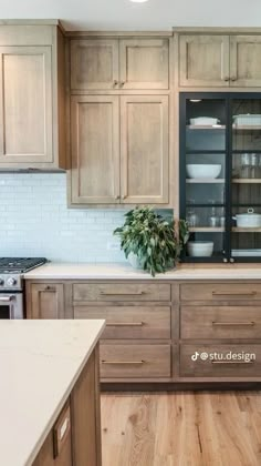 a kitchen with wooden cabinets and white counter tops