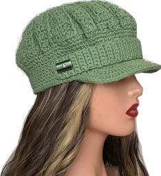 a woman wearing a green hat with a metal pin on it's brim