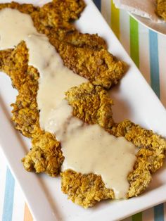 fried chicken with gravy on a white plate