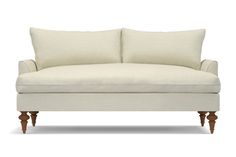 a white couch with two pillows on it