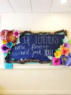 a chalkboard with flowers on it in an office