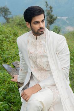 White sherwani with embroidery, sequin work and attached drape on the side. Comes with white kurta, pants and juttis.
Components:4
Pattern:Embroidery
Type of Work:Thread Embroidery and Sequin
Neckline:Band
Sleeve Length:Full
Fabric:Bhagalpuri Silk and Cotton Silk
Color:White
Other Details:
Pleat detail
Attached drape
Side slits
Occasion:Wedding - Aza Fashions White Thread Embroidery, White Sherwani, Kurta Pants, Kurta Set For Men, White Kurta, Pattern Embroidery, Cotton Embroidery, Thread Embroidery, Kurta Set