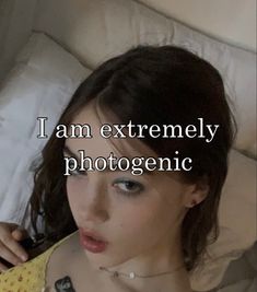 a woman laying in bed with the words i am extremely photogenic on her chest