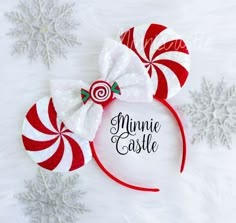 a minnie mouse ears with candy canes on it and snowflakes in the background