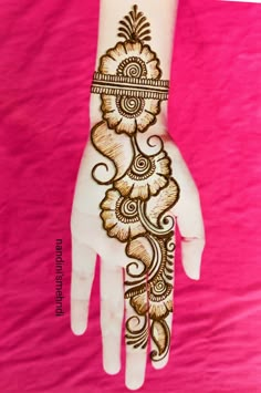 the hand is decorated with henna designs