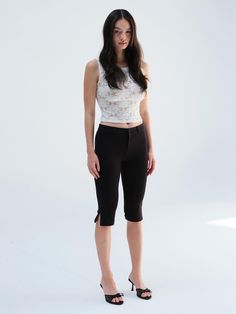 The Juni Capri Pants offer a sleek and modern silhouette perfect for any casual or semi-formal occasion. These pants are designed with a comfortable fit and a stylish knee-length cut that complements a variety of tops and shoes. They feature subtle side slits for added mobility and a touch of unique style. - These Juni Capri Pants include a zip and button closure for a secure and tailored fit.- The knee-length cut is both stylish and versatile, suitable for different occasions.- The subtle side slits enhance mobility and add a unique design element.- A handmade Cali medal decoration has been attached to the lower right side of the front panel to add a unique point of interest. Stretch Cropped Leg Capris For Business Casual, Stretch Capris For Business Casual, Fitted Knee-length Shorts For Business Casual, Fitted Workwear Capri Pants, Fitted Capri Length Pants For Work, Fitted Capri Length Work Pants, Chic Cropped Leg Elastane Pants, Fitted Capri Length Bottoms For Work, Elegant Stretch Pants With Short Length