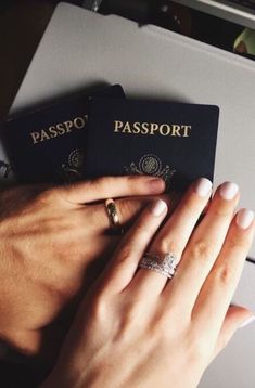 two people are holding their hands together to each other while wearing rings on their fingers