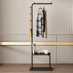 a coat rack with two coats hanging on it in front of a bench and wall