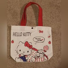 This Listing Is For A Brand New Without Tags (Bnwot) Hello Kitty Tote Bag. This Tote Bag Is Adorable! It Feels Like A Light Canvas Material. It Has An Adorable Graphic, Which Is The Same On Both Sides Of The Bag. The Tote Bag Is Red, White, Black With A Little Bit If Blue, And It Snaps Shut. The Measurements Are Shown In The Photos. Please Leave A Comment Below If You Have Any Questions. Offers Are Always Welcome! Remember To Bundle And Save! I Will Send You An Awesome Offer On Your Bundle ! Tha Cute Red Bags For Everyday Use, Fun White Canvas Bag For Everyday Use, Fun Red Bags For Everyday Use, Fun Red Bags For Daily Use, Fun White Shoulder Bag For School, White Hello Kitty Bag For Daily Use, Casual Hello Kitty Bags For Daily Use, Cute White Shopping Bag, Fun White Bags For Shopping