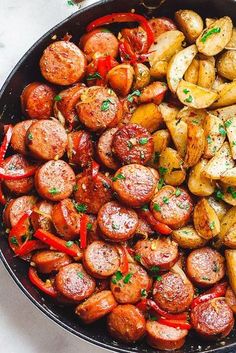 a skillet filled with potatoes and sausage