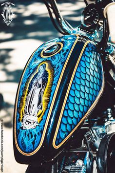 a blue motorcycle with a virgin mary painted on the side