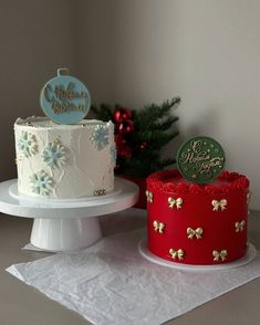 two decorated cakes sitting on top of a table