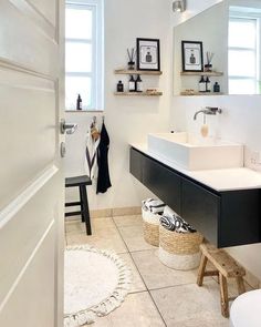 a white bathroom with black and white decor