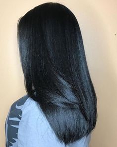 the back of a woman's head with long black hair