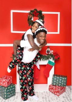 a man and woman in matching pajamas hugging each other