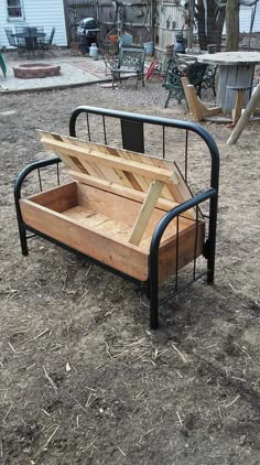 a wooden bench sitting on top of dry grass