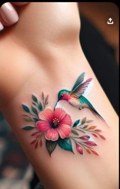 a humming bird with flowers on its chest