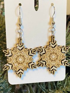 Treat yourself and a friend to a pair of these gorgeous, hand painted and slightly shimmery snowflake earrings.   This is my original design made of wood which has been laser cut and engraved with lots of very pretty delicate detail.  These earrings are extremely lightweight and so comfortable to wear, you'll forget you have them on until someone compliments you.  The ear wires are fishhook style in stainless steel.  A great addition to your holiday wardrobe!  These are also the perfect gift for Snowflake Earrings, Jewelry Minimalist, Small Gift Boxes, Original Jewelry, Engraved Wood, Delicate Details, Wood Earrings, Small Gifts, Minimalist Design