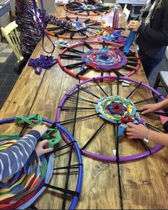 several children playing with different colored toys on a table