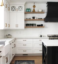 the kitchen is clean and ready for us to use it's white cabinetry