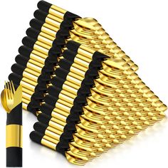 a stack of black and gold forks next to each other with one fork stuck in the middle